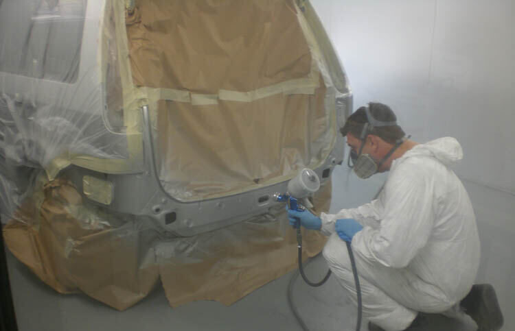 Painter at work in the spray booth